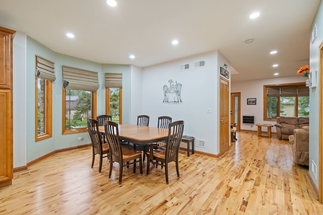 dining area with light wood-type flooring and plenty of natural light