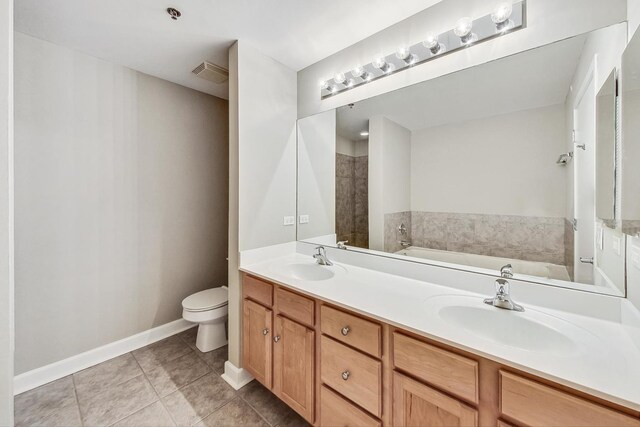 bathroom with a bath, tile patterned flooring, vanity, and toilet