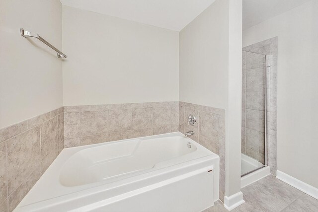 bathroom featuring shower with separate bathtub and tile patterned flooring