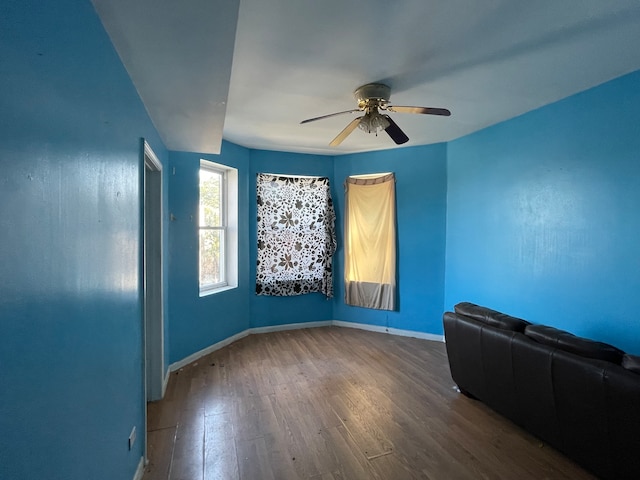 spare room with ceiling fan and dark hardwood / wood-style flooring