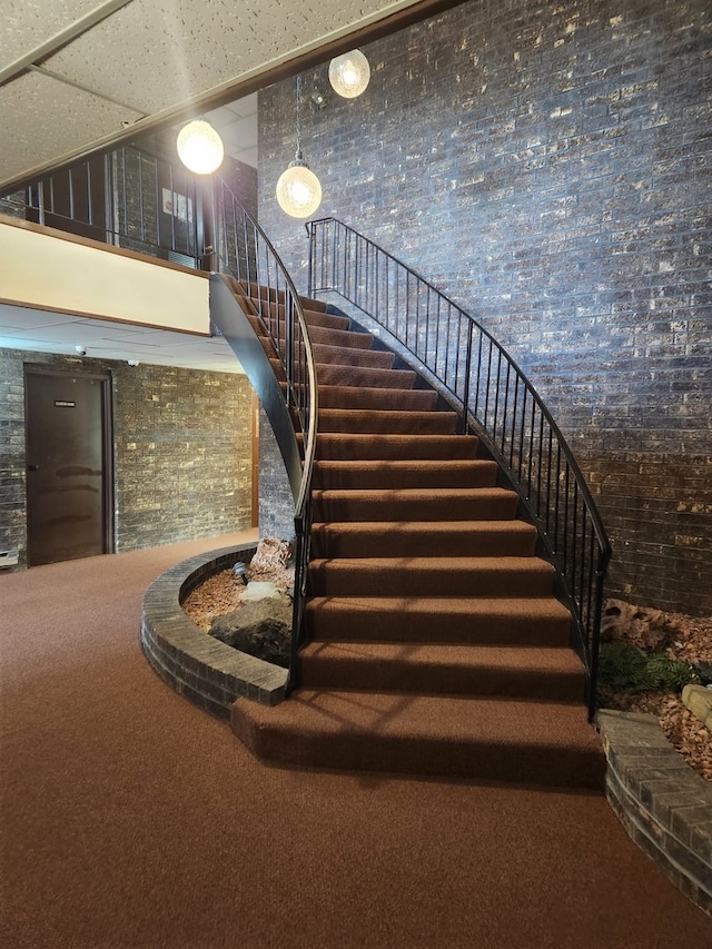 stairs with a towering ceiling and carpet