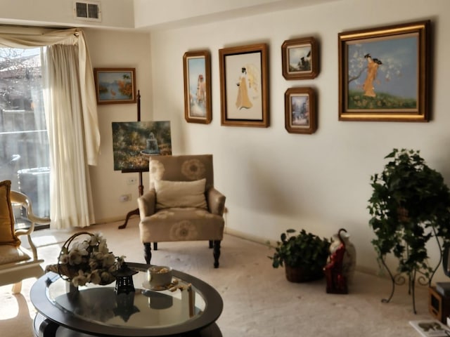 living area with baseboards, carpet, and visible vents