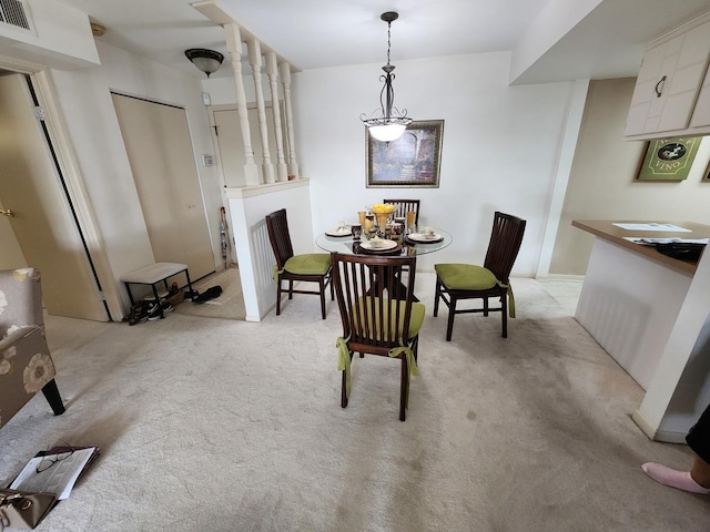 dining room featuring light colored carpet and visible vents