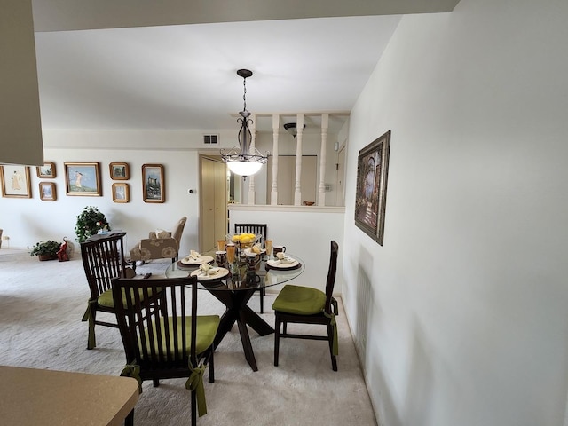 dining space featuring visible vents and light carpet