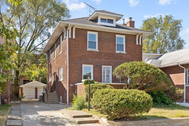 view of front facade featuring an outbuilding, a garage, and central AC unit