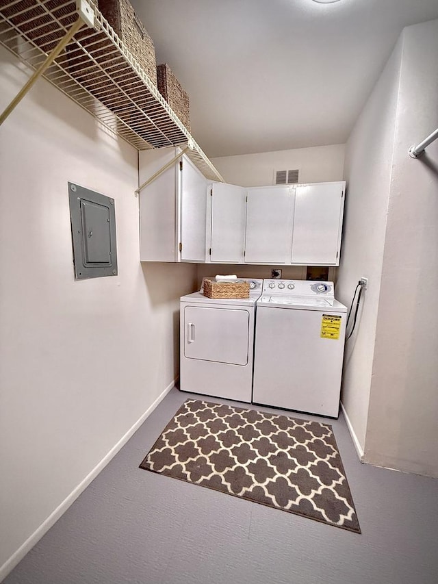 laundry area featuring cabinets, electric panel, and washing machine and clothes dryer