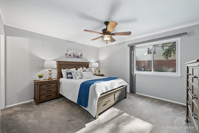 carpeted bedroom featuring ceiling fan and crown molding