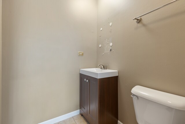 bathroom with tile patterned flooring, vanity, and toilet