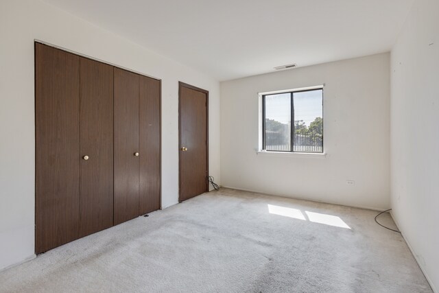 unfurnished bedroom with light colored carpet