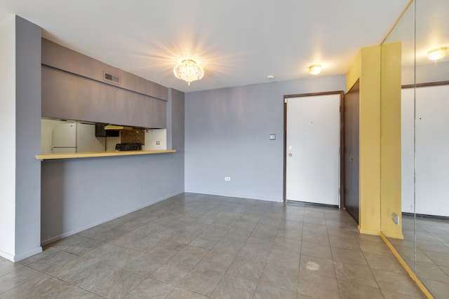 unfurnished living room featuring light tile patterned flooring