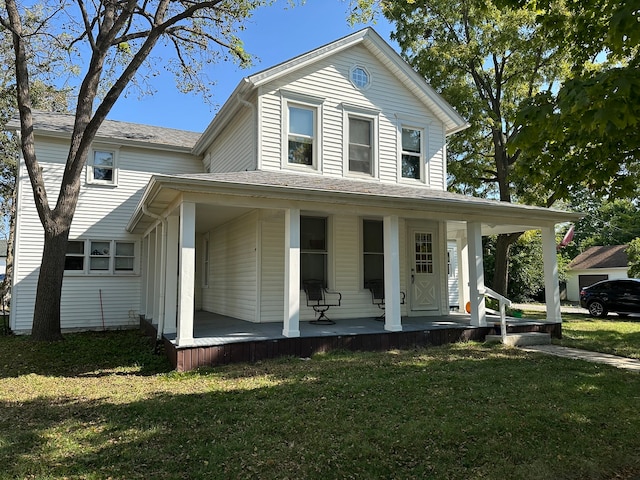 view of front of house featuring a front lawn and covered porch