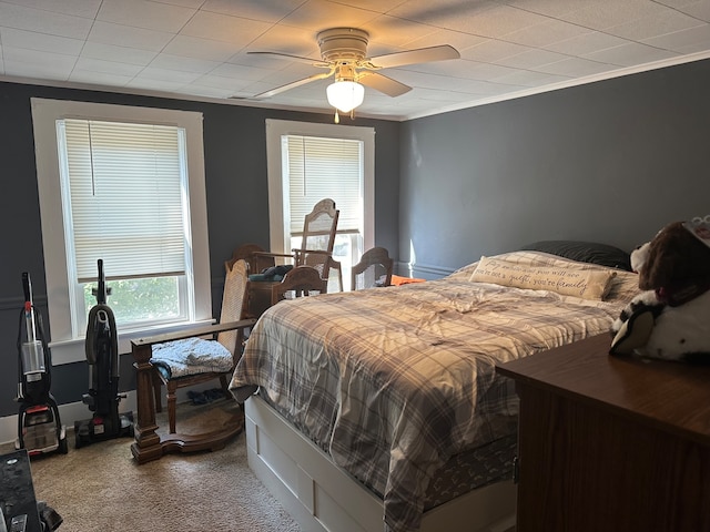 bedroom with carpet, crown molding, and ceiling fan