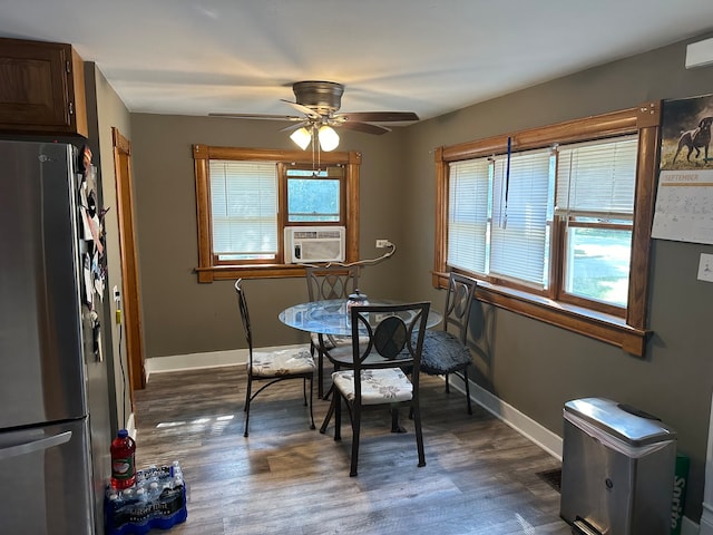 dining space featuring ceiling fan, plenty of natural light, and dark wood-type flooring