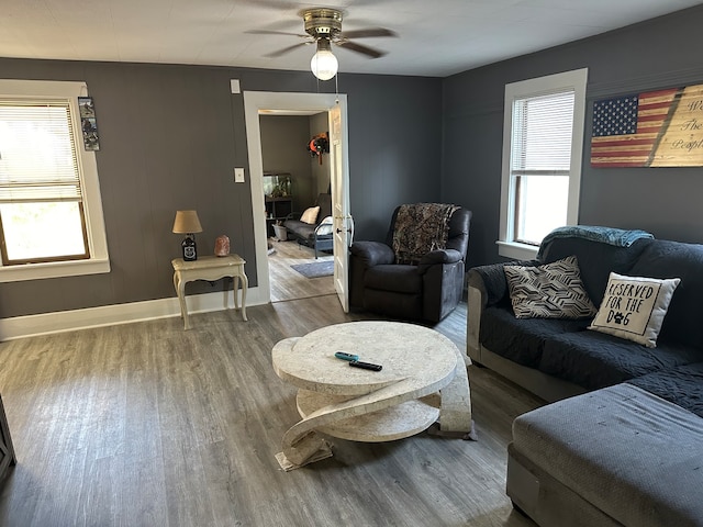 living room featuring wood-type flooring and ceiling fan