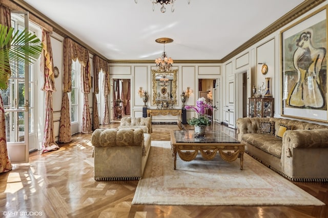 living room with an inviting chandelier, ornamental molding, and light parquet flooring