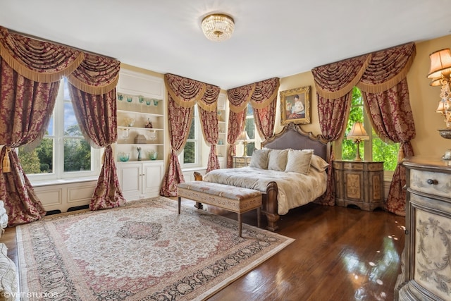 bedroom with dark hardwood / wood-style flooring