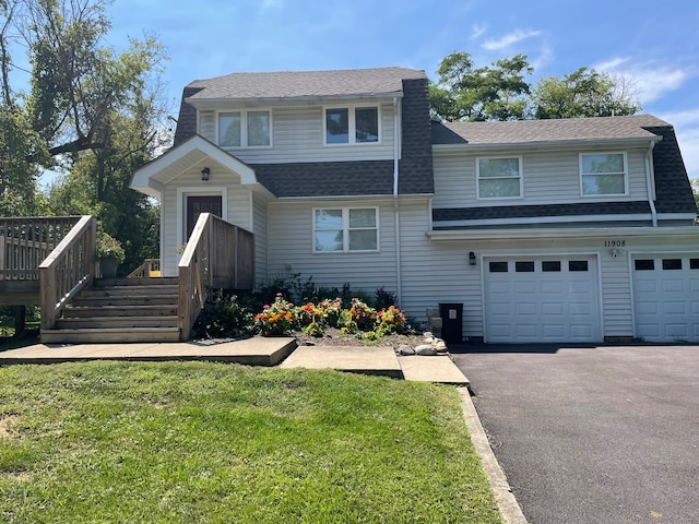 front of property featuring a front lawn and a garage