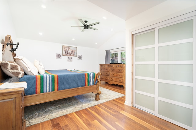 bedroom with ceiling fan, hardwood / wood-style flooring, and lofted ceiling