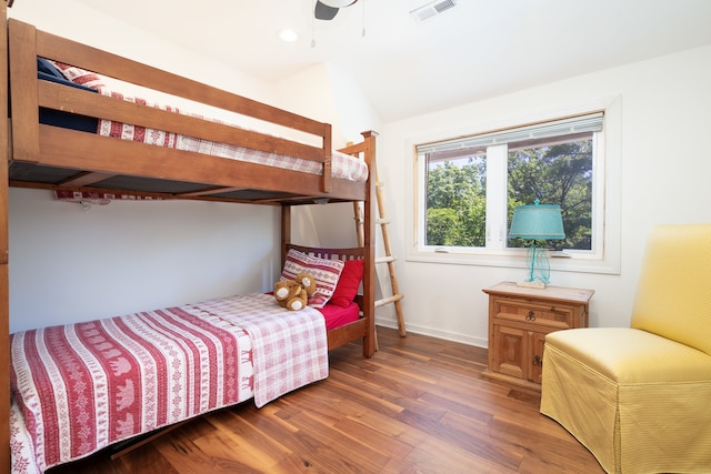 bedroom featuring ceiling fan, dark hardwood / wood-style floors, and vaulted ceiling