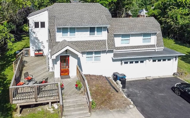 view of front of home with a deck and a garage