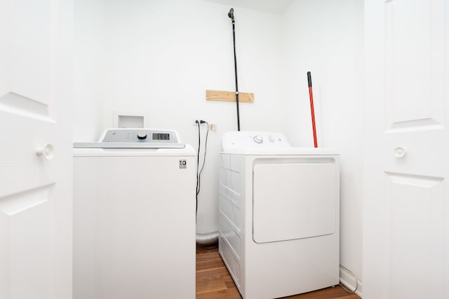 washroom with hardwood / wood-style floors and washer and dryer