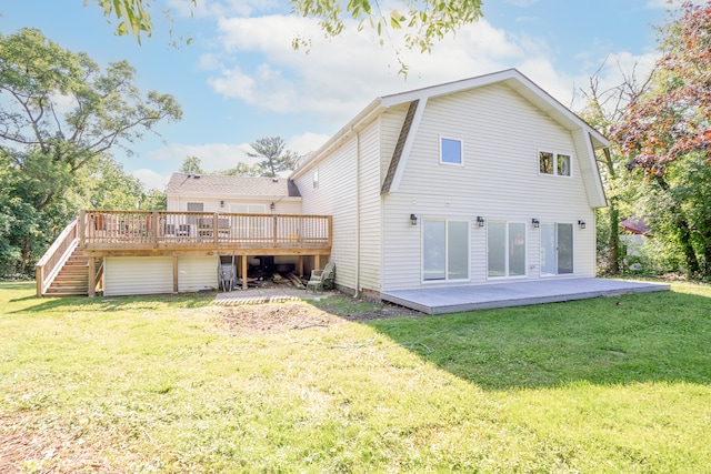 rear view of house featuring a yard and a wooden deck