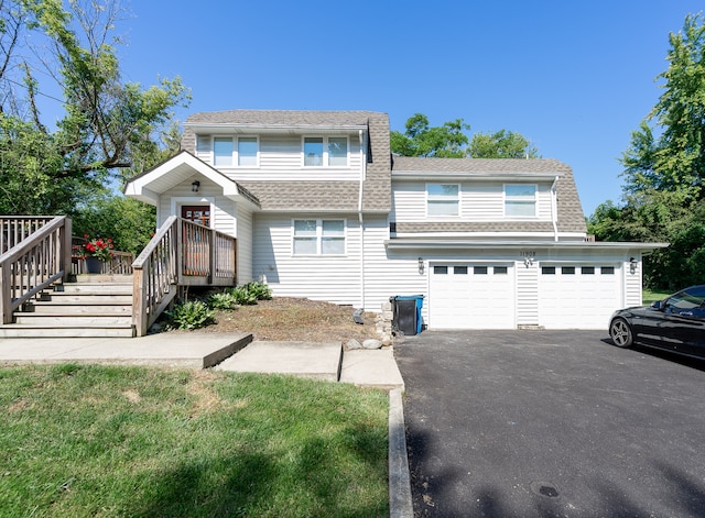 view of front facade featuring a front yard and a garage