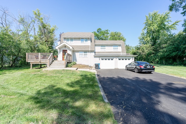 view of front of house with a garage, a wooden deck, and a front lawn