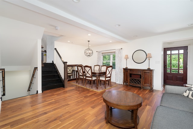 living room featuring a healthy amount of sunlight, beam ceiling, and hardwood / wood-style floors