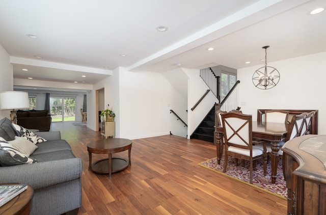 living room with an inviting chandelier and hardwood / wood-style floors