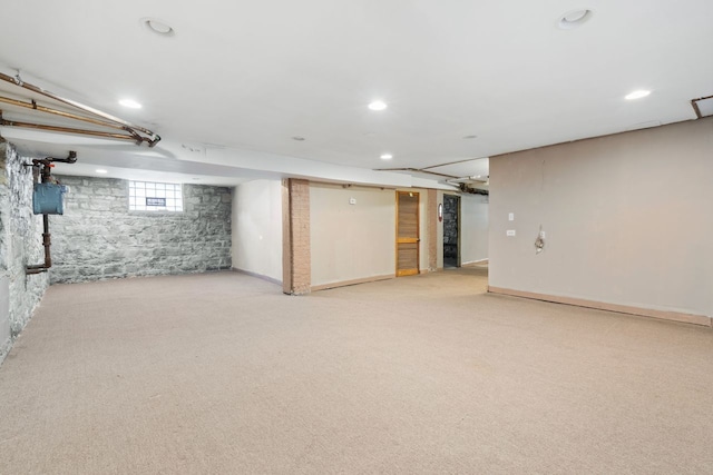 basement featuring light colored carpet