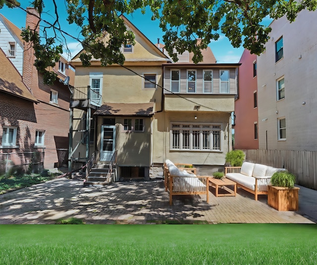 rear view of property with a patio and an outdoor living space