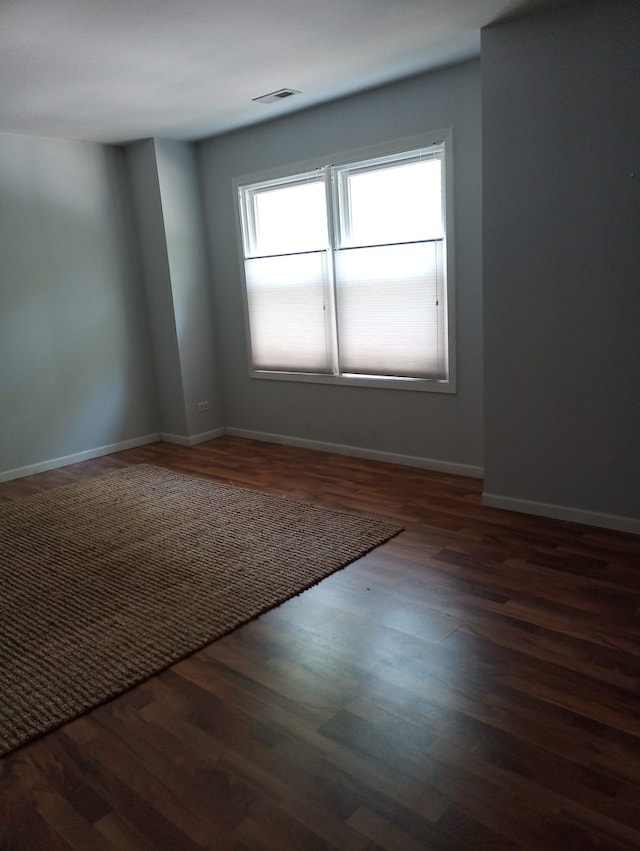 spare room featuring dark hardwood / wood-style floors