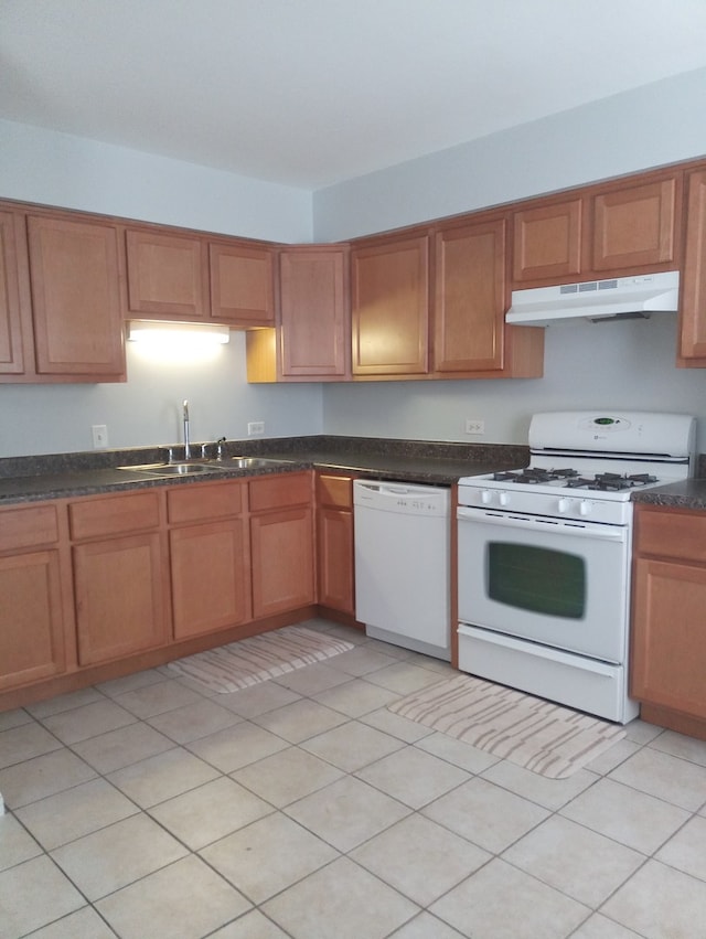 kitchen with light tile patterned flooring, sink, and white appliances