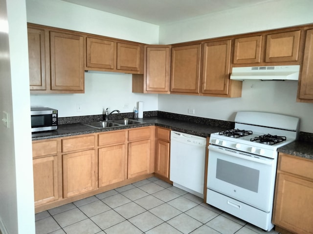 kitchen with white appliances, light tile patterned floors, and sink