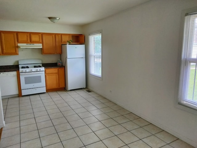 kitchen with white appliances and light tile patterned floors