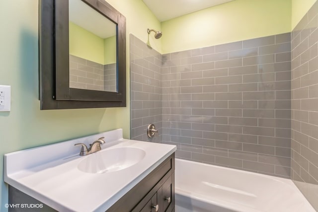 bathroom featuring vanity and tiled shower / bath combo