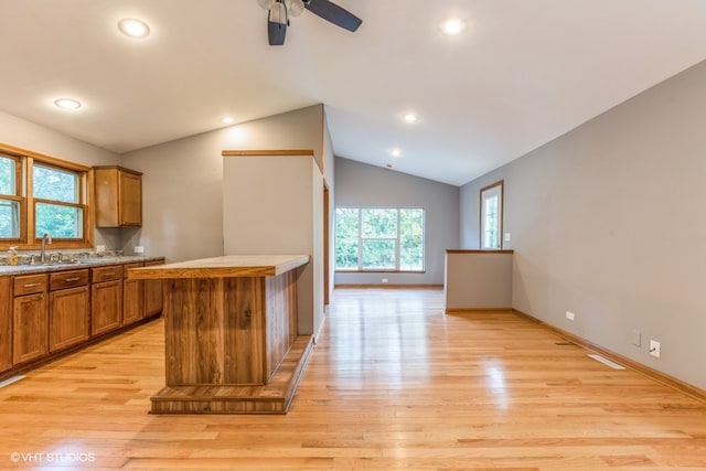 kitchen with light hardwood / wood-style floors, a center island, ceiling fan, and a wealth of natural light