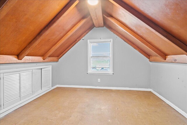 bonus room featuring vaulted ceiling with beams and light parquet flooring