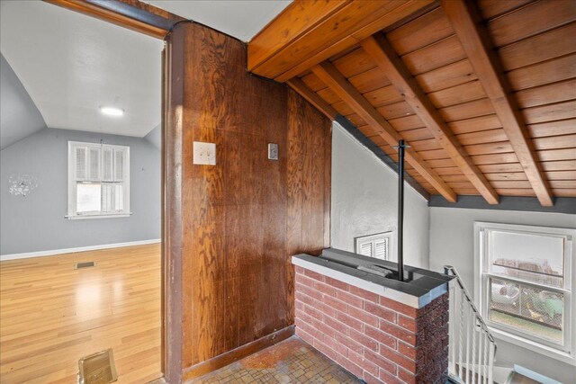 interior space featuring wood-type flooring, vaulted ceiling with beams, and wooden ceiling