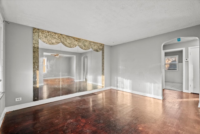 spare room with ceiling fan, hardwood / wood-style flooring, and a textured ceiling