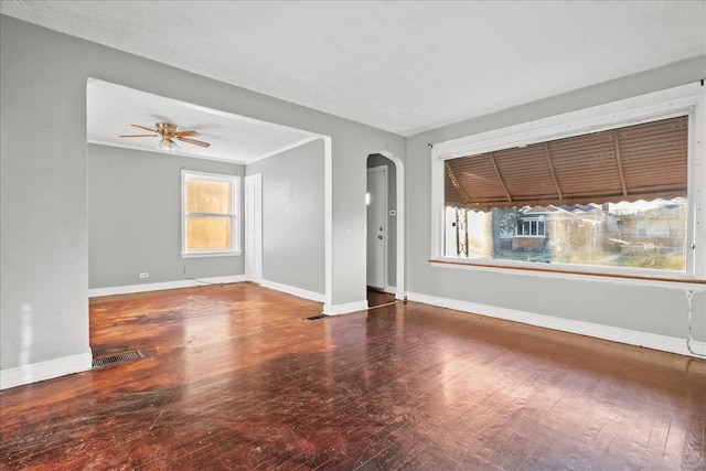 unfurnished room featuring hardwood / wood-style floors, ceiling fan, and a healthy amount of sunlight