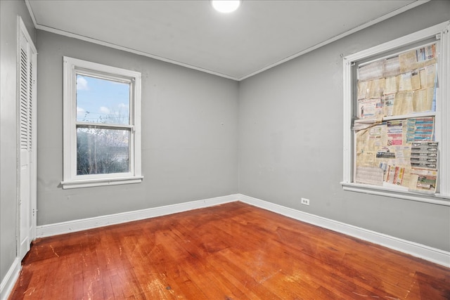 unfurnished room with wood-type flooring and crown molding