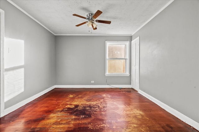 spare room with a textured ceiling, ceiling fan, hardwood / wood-style flooring, and crown molding