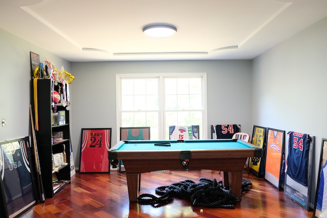 playroom with dark wood-type flooring, pool table, and a tray ceiling