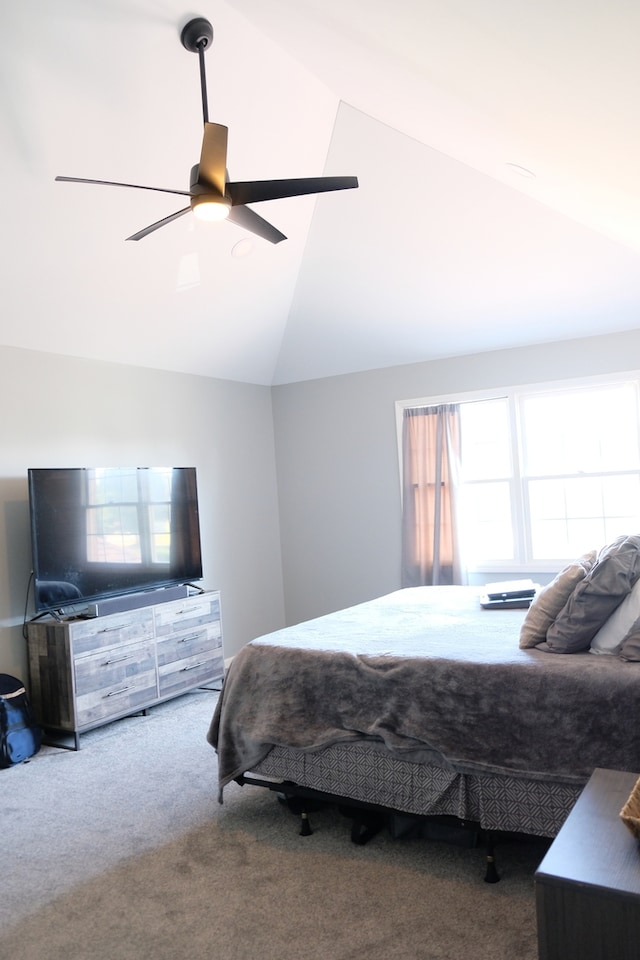 carpeted bedroom with ceiling fan and vaulted ceiling