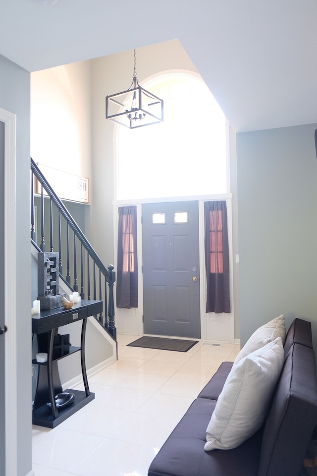 entrance foyer featuring a chandelier and tile patterned flooring