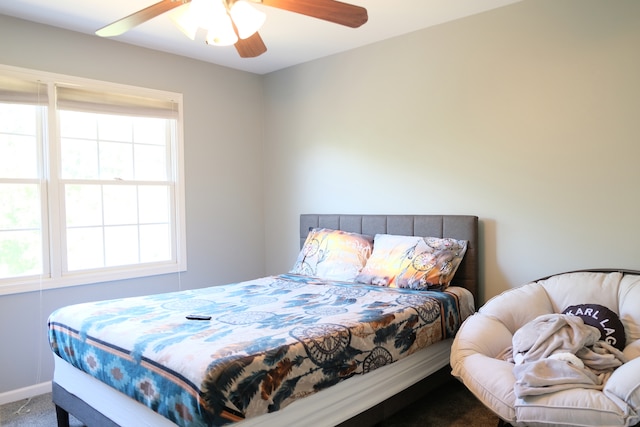 carpeted bedroom featuring ceiling fan