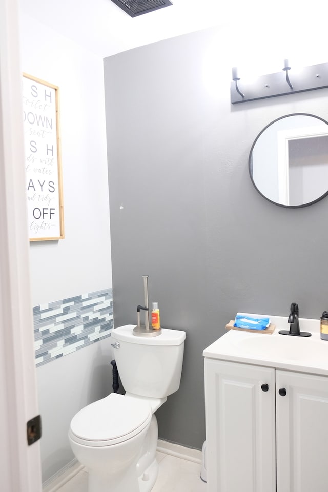 bathroom with vanity, toilet, and tile patterned floors