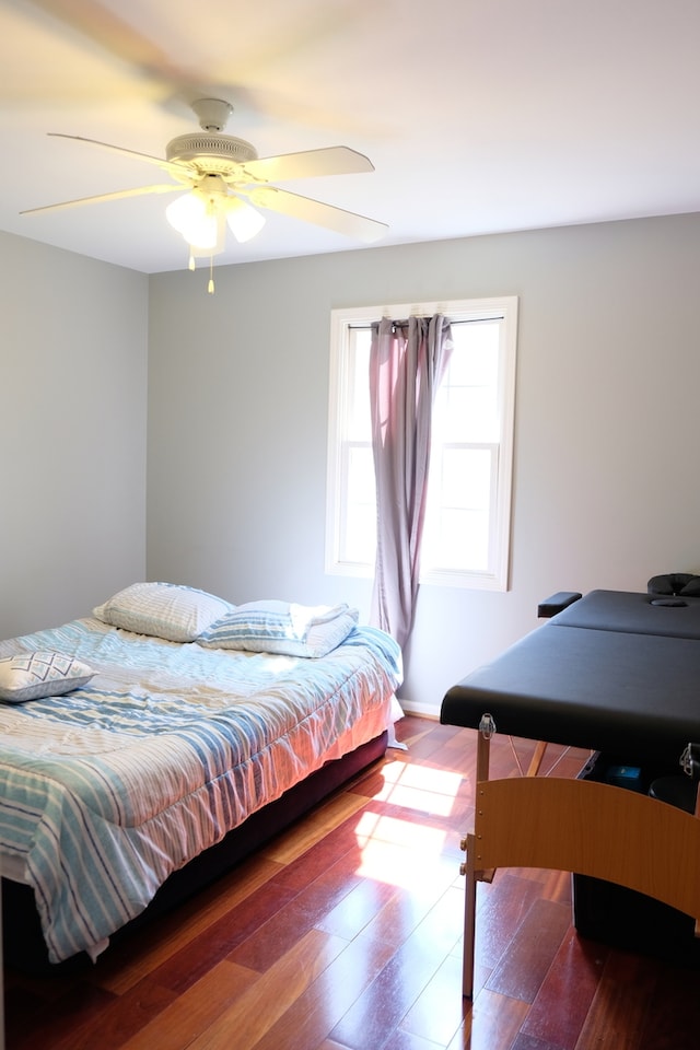 bedroom with hardwood / wood-style flooring and ceiling fan